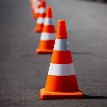 Orange and white striped road safety cones lined up